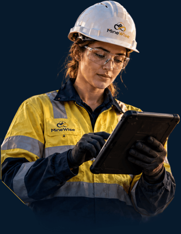 Trainee in PPE reviewing a practical assessment on a tablet